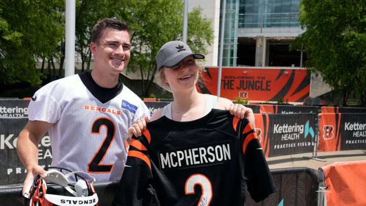 Bengals kicker Evan McPherson takes a photo with fan Ella Engelhardt, 16, of Wyoming Tuesday, May 28, 2024 outside of Paycor Stadium. McPherson along with several other players signed autographs for fans after OTAs.