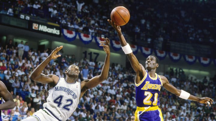 May 1988; Dallas, TX, USA; FILE PHOTO;  Los Angeles Lakers forward Michael Cooper (21) shoots over Dallas Mavericks forward Roy Tarpley (42) during the 1988 NBA Western Conference Finals at Reunion Arena. Mandatory Credit: MPS-USA TODAY Sports