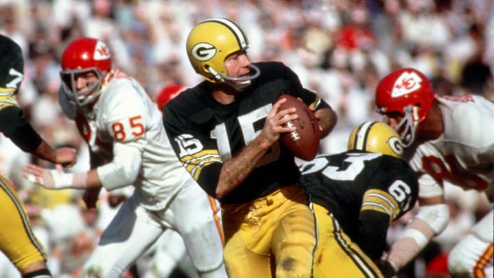 Jan 15, 1987; Los Angeles, CA; USA; Green Bay Packers quarterback (15) Bart Starr in action during Super Bowl I at the Los Angeles Coliseum against the Kansas City Chiefs. The Packers defeated the Chiefs 35-10 to win the first Super Bowl Title. Starr was 16-23 for 250 yards and 2 touchdowns and was named the games most valuable player.  
