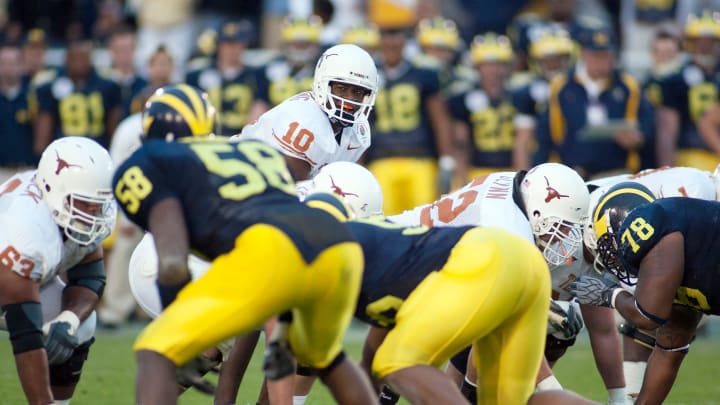 Jan 1, 2005; Pasadena, CA, USA; Texas Longhorns quarterback Vince Young (10) lined up under center Jason Glynn (52) against the Michigan Wolverines in the 2005 Rose Bowl at Rose Bowl Stadium. Mandatory Credit: Richard Mackson-USA TODAY NETWORK