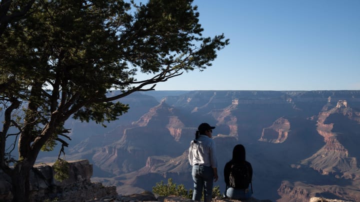 Visitors view the canyon from the Rim Trail on Aug. 5, 2023, at the South Rim of the Grand Canyon. The proposed monument would be mostly north of the Grand Canyon, but supporters say protecting public lands around the national park would protect the surrounding groundwater and the Colorado River from potential contamination.