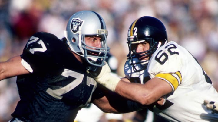 Jan 1, 1984; Los Angeles, CA, USA; FILE PHOTO; Los Angeles Raiders defensive end Lyle Alzado (77) tries to get past Pittsburgh Steelers lineman Tunch Ilkin (62) during the AFC Divisional Playoff Game at Los Angeles Memorial Coliseum. The Raiders defeated the Steelers 38-10. Mandatory Credit: Malcolm Emmons-USA TODAY Sports