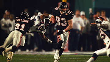 Jan 31, 1999; Miami, FL, USA; FILE PHOTO; Atlanta Falcons cornerback Elijah Williams (31) makes a block for kick returner Tim Dwight (83) against Denver Broncos cornerback Ray Crockett (39) during Super Bowl XXXIII at Dolphin Stadium. The Broncos defeated the Falcons 34-19. Mandatory Credit: RVR Photos-Imagn Images