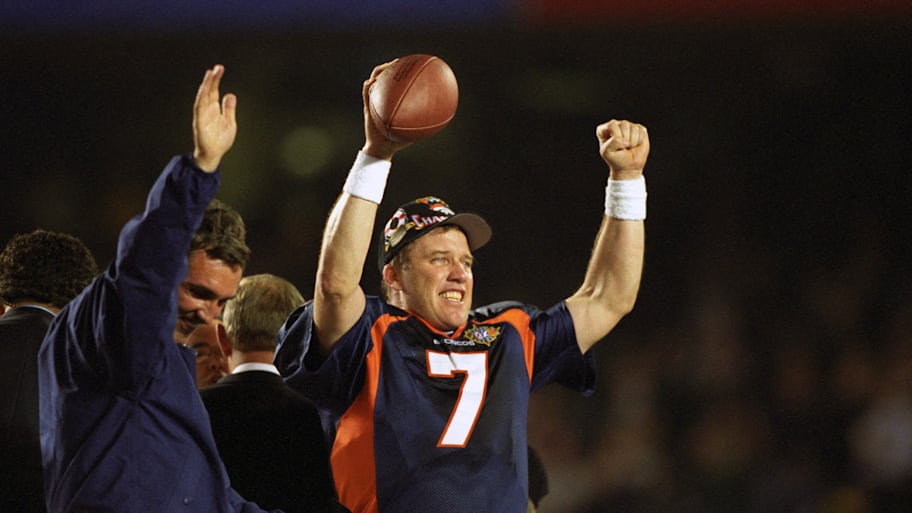 Denver Broncos head coach Mike Shanahan and quarterback John Elway celebrate the Broncos first Super Bowl title.