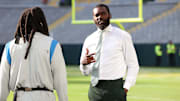 Randy Moss talks with Detroit Lions running back Jamaal Williams (30) before the Green Bay Packers game against the Detroit Lions at Lambeau Field in Green Bay.