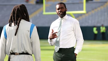 Randy Moss talks with Detroit Lions running back Jamaal Williams (30) before the Green Bay Packers game against the Detroit Lions at Lambeau Field in Green Bay.