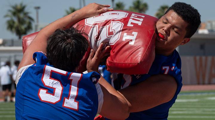 Mountain View OL Tye Kennedy (right, No. 73) runs a drill during Mesa Public Schools spring football showcase, on May 6, 2026.