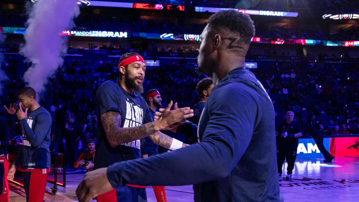 Feb 14, 2024; New Orleans, Louisiana, USA;  New Orleans Pelicans forward Brandon Ingram (14) hugs forward Zion Williamson (1) as he is announced to the fans to start the game against the Washington Wizards during the first half at Smoothie King Center.