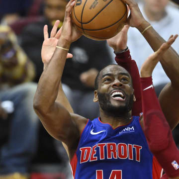 Jan 31, 2024; Cleveland, Ohio, USA; Detroit Pistons guard Alec Burks (14) shoots beside Cleveland Cavaliers forward Isaac Okoro (35) in the fourth quarter at Rocket Mortgage FieldHouse. Mandatory Credit: David Richard-USA TODAY Sports