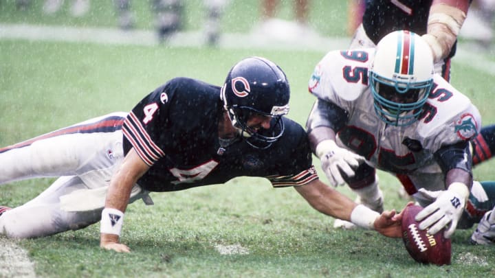 Nov 13, 1994; Miami, FL, USA; Chicago Bears quarterback Steve Walsh (4) and Miami Dolphins defensive tackle Tim Bowens (95) go after a loose ball at Dolphin Stadium.