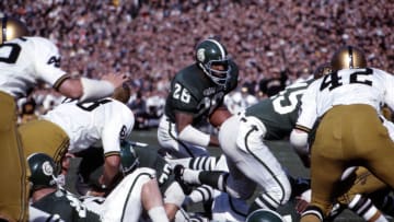 Oct 22, 1966, East Lansing, MI, USA; FILE PHOTO; Michigan State Spartans running back Clinton Jones (26) carries the ball against the Purdue Boilermakers at Spartan Stadium during the 1966 season. Mandatory Credit: Malcolm Emmons-USA TODAY Sports