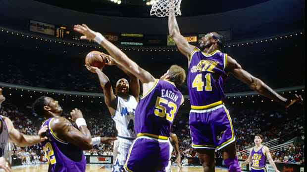 March 4, 1991; Orlando, FL, United States; File photo; The Jazz Center of Utah Mark Eaton (53) and Thurl Bailey (41) defend a blow by Orlando Ma