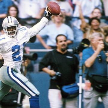 Sep 11, 1997; Irving, TX, USA; FILE PHOTO: Dallas Cowboys  defensive back  Deion Sanders (21) celebrating as he scores a touchdown on an interception against the  Chicago Bears at Texas Stadium. Mandatory Credit: James D. Smith-Imagn Images