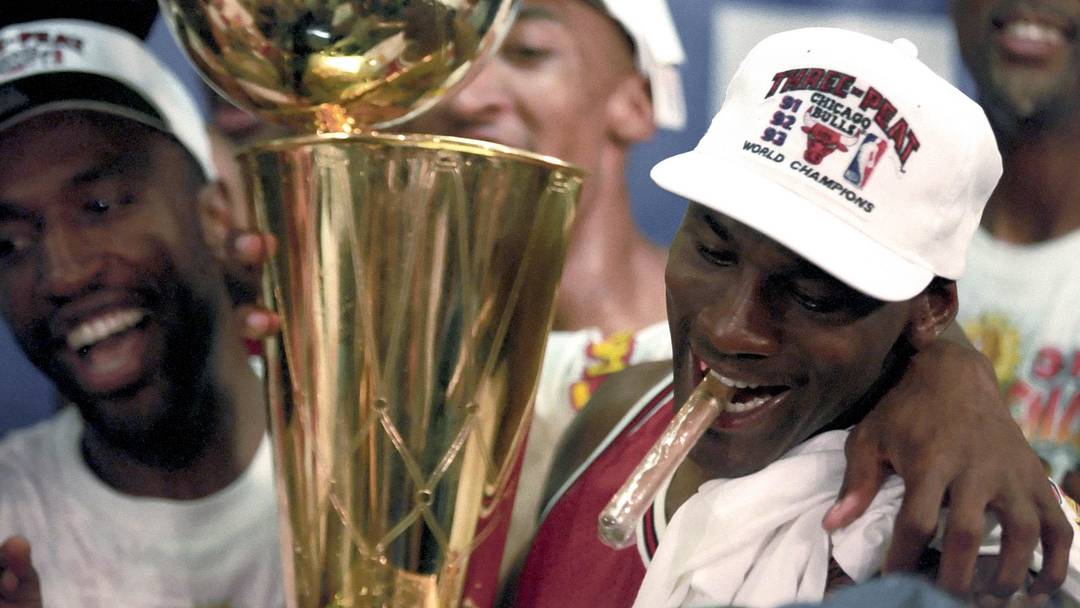 Jun 1993; Phoenix, AZ, USA; FILE PHOTO; Chicago Bulls guard Michael Jordan (right) celebrates with the championship trophy following the Bulls defeating the Phoenix Suns in the 1993 NBA Finals at America West Arena. Mandatory Credit: MPS-Imagn Images