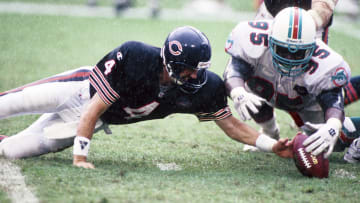Defensive tackle Tim Bowens (95) goes after a loose ball against the Chicago Bears in a 1994 game in Miami.