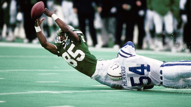 Former Colts linebacker Jeff Herrod (white and blue uniform) makes a diving tackle on a ball-carrier. 