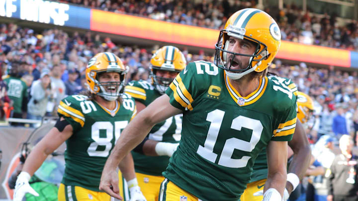 Former Green Bay Packers quarterback Aaron Rodgers running onto the field during an NFL game at Lambeau Field