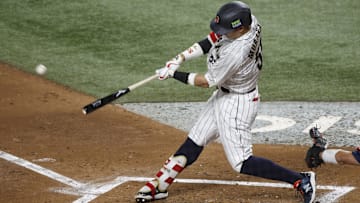 Mar 21, 2023; Miami, Florida, USA; Japan third baseman Munetaka Murakami (55) hits a home run against the USA in the second inning at LoanDepot Park. Mandatory Credit: Rhona Wise-Imagn Images