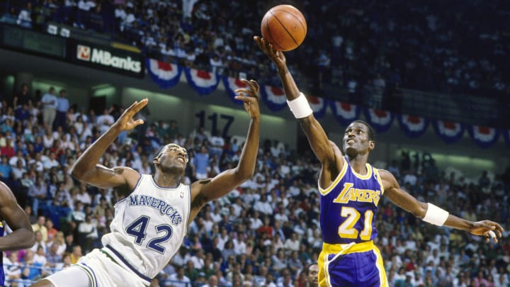 May 1988; Dallas, TX, USA; FILE PHOTO;  Los Angeles Lakers wing Michael Cooper (21) shoots over Dallas Mavericks forward Roy Tarpley (42) during the 1988 NBA Western Conference Finals at Reunion Arena. Mandatory Credit: MPS-USA TODAY Sports