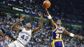 May 1988; Dallas, TX, USA; FILE PHOTO;  Los Angeles Lakers forward Michael Cooper (21) shoots over Dallas Mavericks forward Roy Tarpley (42) during the 1988 NBA Western Conference Finals at Reunion Arena. Mandatory Credit: MPS-USA TODAY Sports