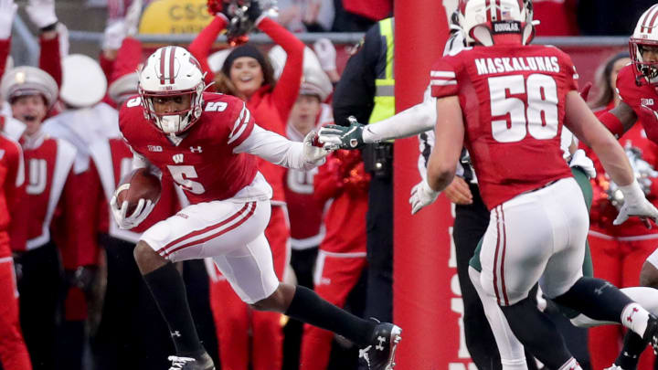 Badgers cornerback Rachad Wildgoose looks for room to run after intercepting a pass late in the game against Michigan State.