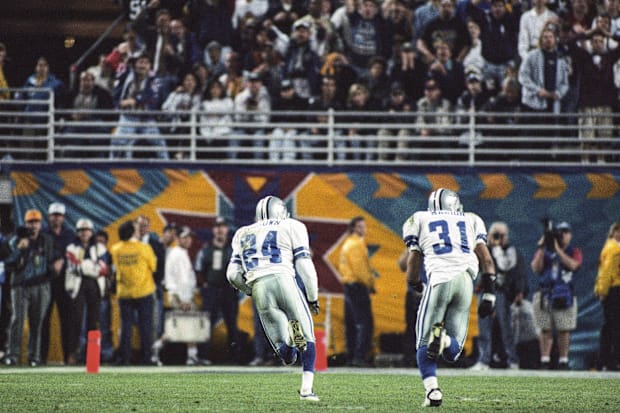 Dallas Cowboys cornerback Larry Brown (24) carries the ball after intercepting a pass from Pittsburgh Steelers quarterback