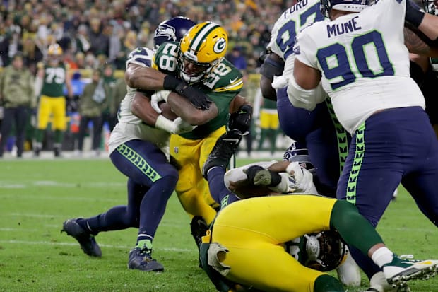 A.J. Dillon (28) scores his first of two touchdowns during the fourth quarte