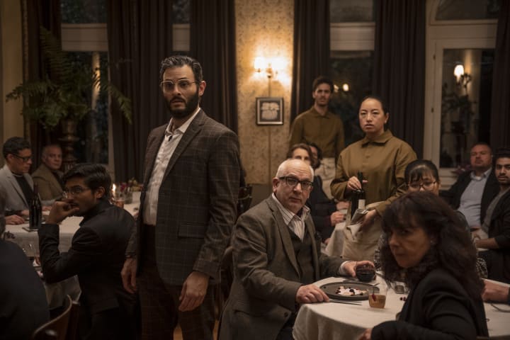  A crowded restaurant, several patrons look at someone off-camera