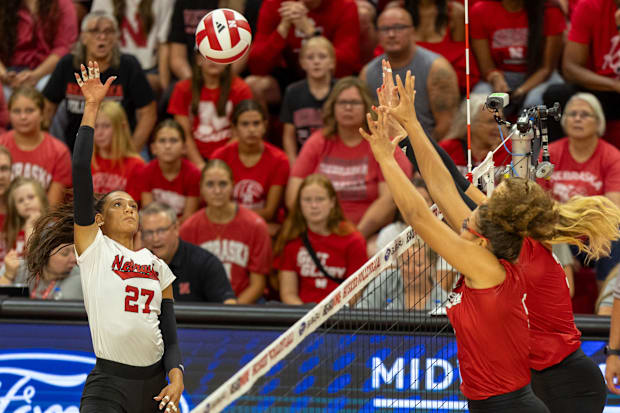 Nebraska outside hitter Harper Murray lobs the ball over Rebekah Allick and Allie Sczech during the Red-White Scrimmage.