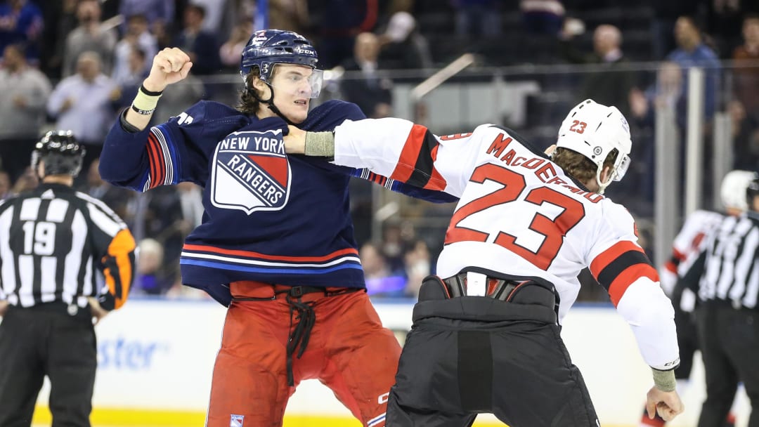 Apr 3, 2024; New York, New York, USA; New York Rangers center Matt Rempe (73) and New Jersey Devils defenseman Kurtis MacDermid (23) fight at start of the 1st period at Madison Square Garden. Mandatory Credit: Wendell Cruz-USA TODAY Sports