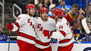 Oct 19, 2024; St. Louis, Missouri, USA;  Carolina Hurricanes center Jack Roslovic (96) is congratulated by defenseman Jaccob Slavin (74) and left wing Eric Robinson (50) after scoring against the St. Louis Blues during the third period at Enterprise Center. Mandatory Credit: Jeff Curry-Imagn Images