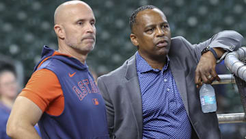 Houston Astros manager Joe Espada (left) and general manager Dana Brown (right) talk on the field before the game against the Chicago Cubs at Daikin Park.