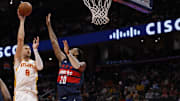 Nov 25, 2025; Washington, District of Columbia, USA; Atlanta Hawks center Kristaps Porzingis (8) shoots the ball over Washington Wizards center Alex Sarr (20) in the first half at Capital One Arena. Mandatory Credit: Geoff Burke-Imagn Images