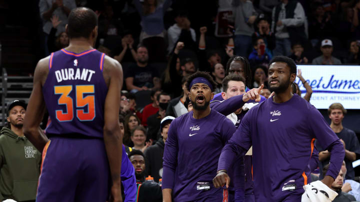 Dec 17, 2023; Phoenix, Arizona, USA; Phoenix Suns guard Jordan Goodwin (left) and forward Chimezie Metu (right) celebrate after forward Kevin Durant (35) makes a basket against the Washington Wizards during the second half at Footprint Center. Mandatory Credit: Zachary BonDurant-USA TODAY Sports