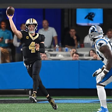 New Orleans Saints quarterback Derek Carr (4) throws on the run against the Carolina Panthers