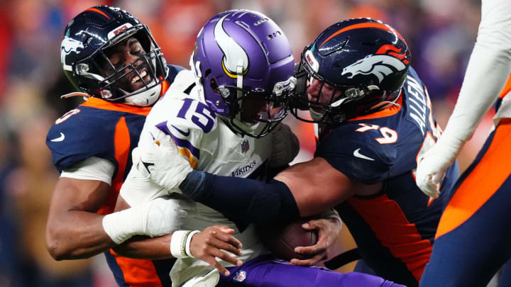 Nov 19, 2023; Denver, Colorado, USA; Minnesota Viking quarterback Joshua Dobbs (15) is sacked by Denver Broncos linebacker Jonathon Cooper (0) and defensive end Zach Allen (99) in the first half at Empower Field at Mile High. Mandatory Credit: Ron Chenoy-USA TODAY Sports