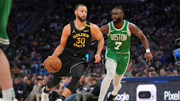 Golden State Warriors guard Stephen Curry dribbles past Boston Celtics forward Jaylen Brown