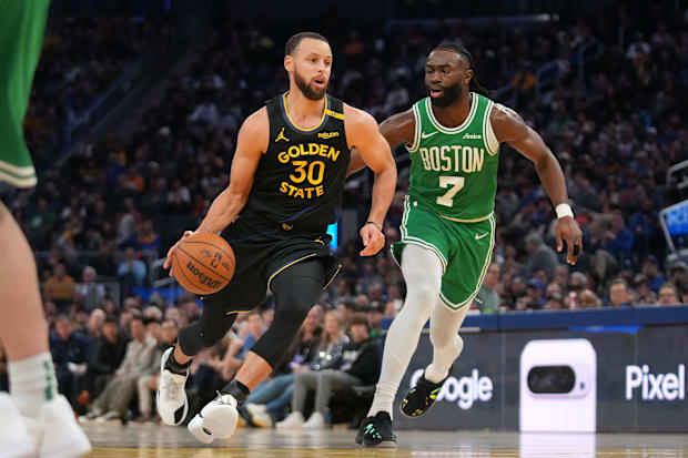 Golden State Warriors guard Stephen Curry (30) dribbles past Boston Celtics forward Jaylen Brown (7)
