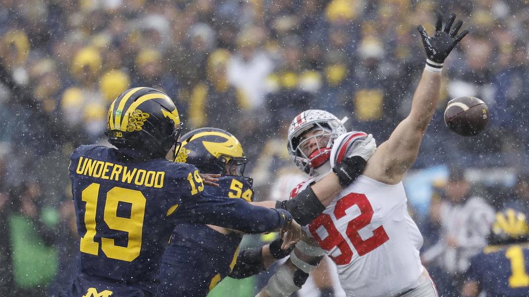 Nov 29, 2025; Ann Arbor, Michigan, USA;  Michigan Wolverines quarterback Bryce Underwood (19) passes under pressure from Ohio State Buckeyes defensive end Caden Curry (92) at Michigan Stadium. Mandatory Credit: Rick Osentoski-Imagn Images