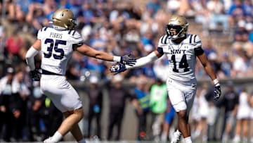 Oct 5, 2024; Colorado Springs, Colorado, USA; Navy Midshipmen safety Jaxson Campbell (14) reacts with defensive end Luke Pirris (35) after a play in the fourth quarter against the Air Force Falcons at Falcon Stadium. Mandatory Credit: Isaiah J. Downing-Imagn Images