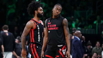 Nov 28, 2023; Boston, Massachusetts, USA; Chicago Bulls guard Ayo Dosunmu (12) and guard Coby White (0) return to the bench during a break in the action against the Boston Celtics in the second half at TD Garden. Mandatory Credit: David Butler II-Imagn Images
