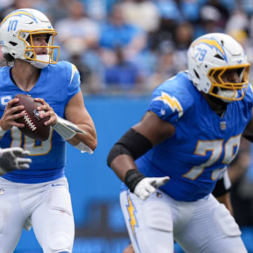 Sep 15, 2024; Charlotte, North Carolina, USA; Los Angeles Chargers quarterback Justin Herbert (10) looks for an open receiver against the Carolina Panthers during the second half at Bank of America Stadium. Mandatory Credit: Jim Dedmon-Imagn Images