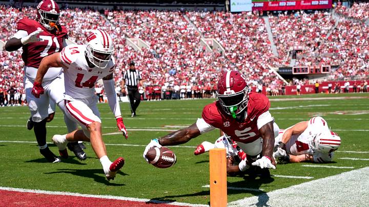 Sep 13, 2025; Tuscaloosa, Alabama, USA; Alabama wide receiver Germie Bernard (5) dives for a score at the pylon with Wisconsin defensive back Preston Zachman (14), Wisconsin defensive back D'Yoni Hill (5) and Wisconsin linebacker Tackett Curtis (4) unable to make the stop at Saban Field at Bryant-Denny Stadium. Mandatory Credit: Gary Cosby Jr.-Imagn Images