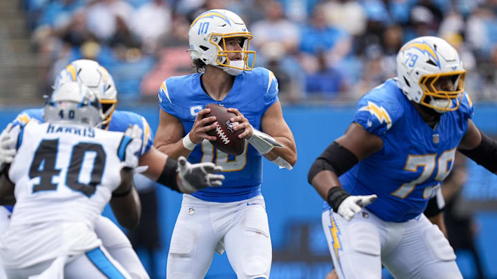 Sep 15, 2024; Charlotte, North Carolina, USA; Los Angeles Chargers quarterback Justin Herbert (10) looks for an open receiver against the Carolina Panthers during the second half at Bank of America Stadium. Mandatory Credit: Jim Dedmon-Imagn Images