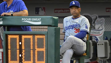 Sep 3, 2024; Anaheim, California, USA;  Los Angeles Dodgers manager Dave Roberts (30) looks on from the dugout against the Los Angeles Angels at Angel Stadium. Mandatory Credit: Jayne Kamin-Oncea-Imagn Images