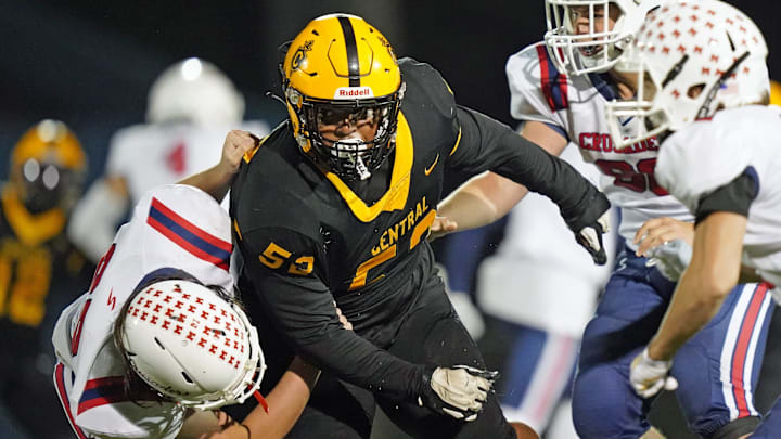 Daniel Cordero, middle, competes for the Central varsity football team last season.