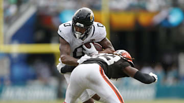 Sep 15, 2024; Jacksonville, Florida, USA; Jacksonville Jaguars wide receiver Gabe Davis (0) avoids a tackle by Cleveland Browns cornerback Martin Emerson Jr. (23) during the fourth quarter at EverBank Stadium. 
