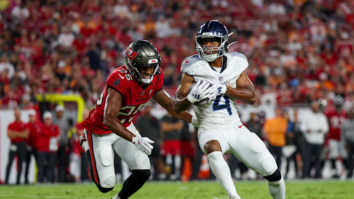 Tennessee Titans wide receiver Tyler Lockett is tackled by Tampa Bay Buccaneers cornerback Jacob Parrish.