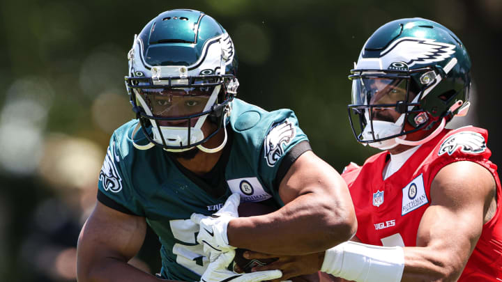 May 30, 2024; Philadelphia, PA, USA; Philadelphia Eagles quarterback Jalen Hurts (1) hands off to running back Saquon Barkley (26) during practice at NovaCare Complex.  