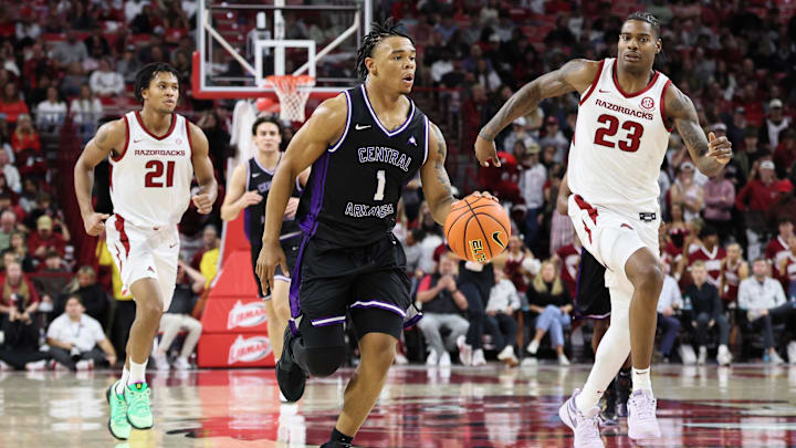 Nov 11, 2025; Fayetteville, Arkansas, USA; UCA Bears guard Camren Hunter (1) leads a fast break as Arkansas Razorbacks guard D.J. Wagner (21) and forward Nick Pringle (23) look on during the second half at Bud Walton Arena. Arkansas won 93-56. Mandatory Credit: Nelson Chenault-Imagn Images